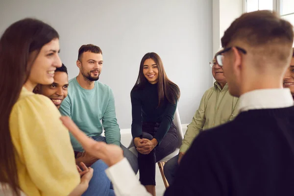 Multiracial people sit in a circle and listen to the story of the participant of the meeting. — Stock Photo, Image