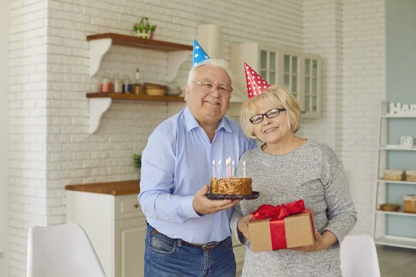 头戴彩色礼帽的老夫妇在家里庆祝生日或结婚周年纪念日. — 图库照片