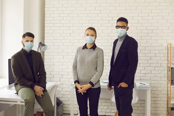 People wear face masks in office, caring about health of customers and coworkers — Stock Photo, Image