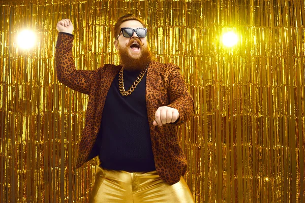 Happy bearded man in crazy outfit dancing gangnam style and having fun at a party