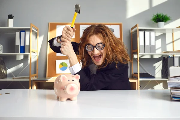 Crazy man wants to break his piggy bank with hammer and invest his money in business
