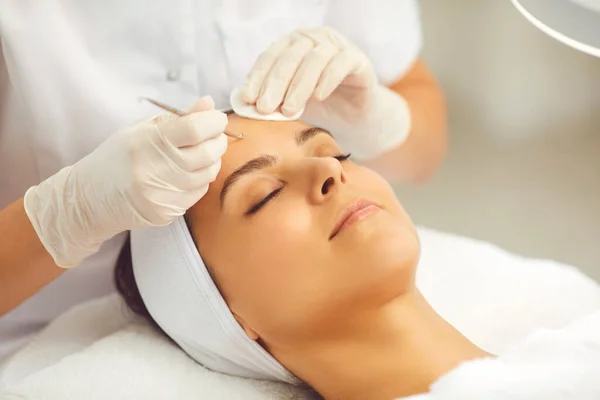 Mujer cara conseguir poros faciales limpieza con aguja vidale metal especial de cosmetólogo — Foto de Stock