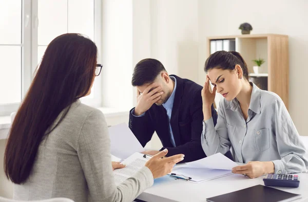 Couple getting very bad news from their lawyer, real estate agent or bank manager — Stock Photo, Image