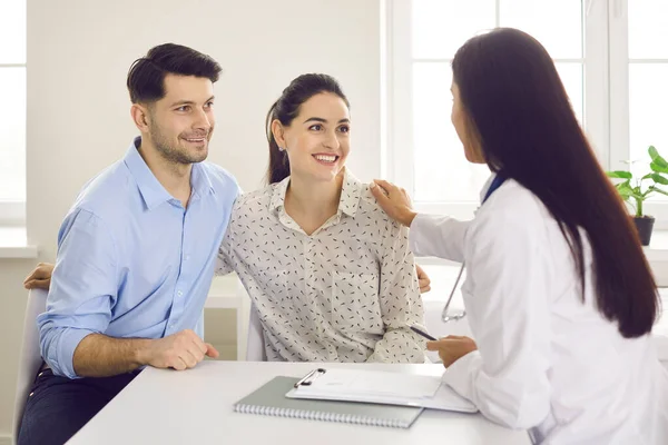 Happy young couple planning pregnancy and visiting their family practitioner together — Stock Photo, Image