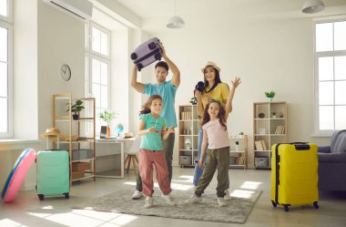 Mutlu ebeveynler ve küçük çocuklar yaz tatiline giderken eğlenin ve bavullarını toplayın..