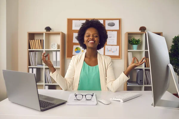 Ung kvinna sitter på kontoret skrivbord och meditera fokuserar bara på positiva känslor — Stockfoto