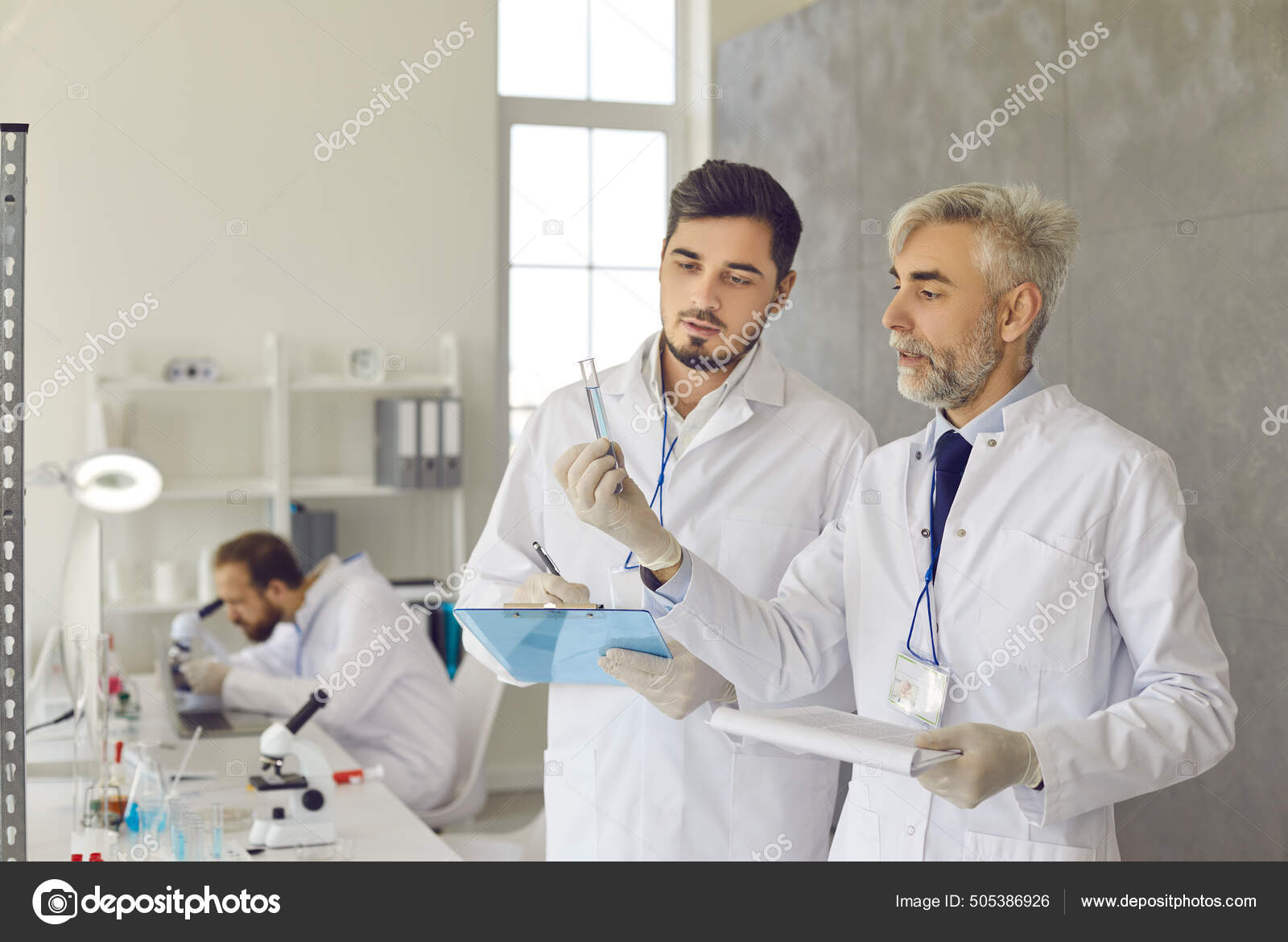 Scientists in white lab coats and gloves working on a new effective