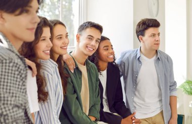 Diverse group of young happy graduate students, teens, college friends close together. Youth unity motivation enthusiasm, positive communication skill, developing friendly community of people around