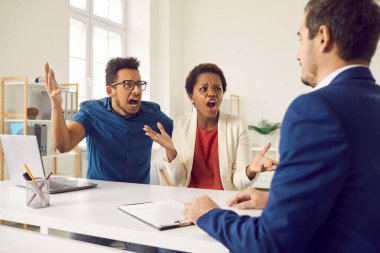 Disgruntled bankrupt clients fighting bank worker. Dissatisfied indignant emotional rude man and woman with angry face expressions arguing, shouting, demanding to explain outrageous contract condition