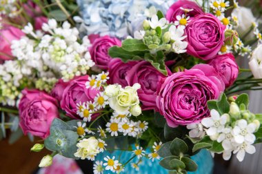 Şakayık gülleri ve yaz çiçekleri vazosunda bir buket çiçek.