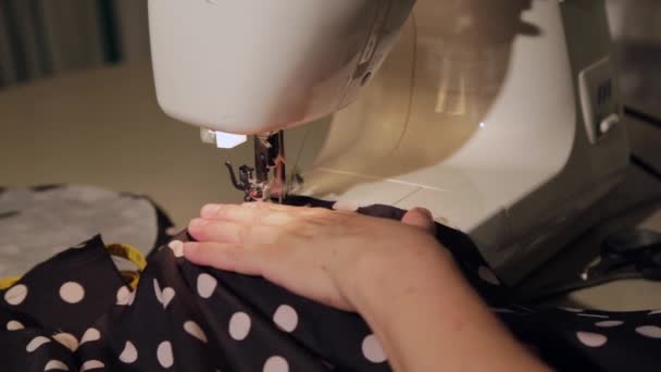 Close up shot of a tailor behind a sewing machine — Stock Video