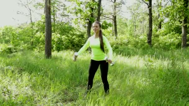 Femme faisant des exercices avec haltère dans le parc — Video