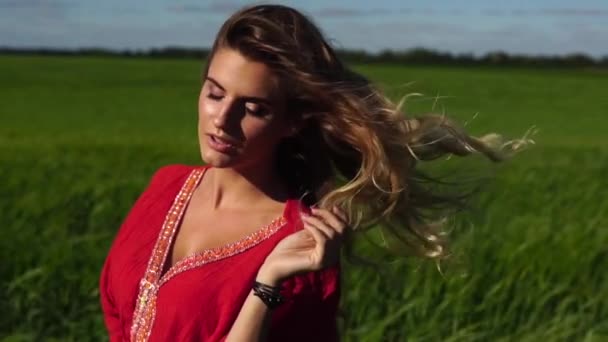 Lycklig kvinna njuter av naturen vacker blondin poserar på fältet. Glad koncept. — Stockvideo