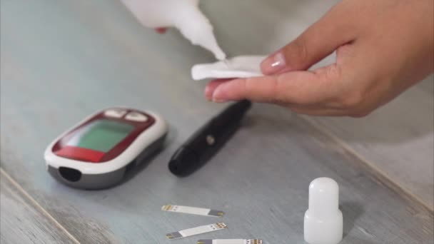 Close up of female hands taking blood sample for blood sugar testing — Stock Video