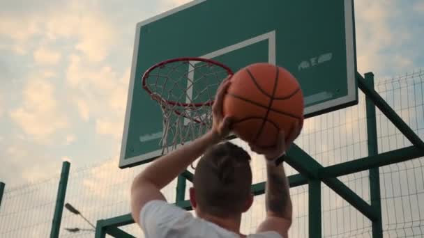 Basketball training of young man throwing ball into hoop — Stock Video