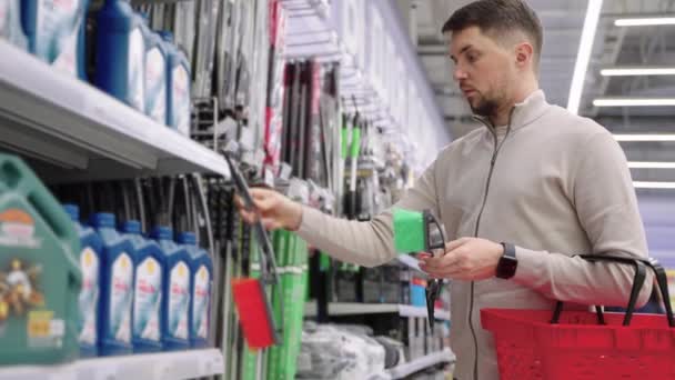 Man shopper kopen voorruit borstel voor auto — Stockvideo