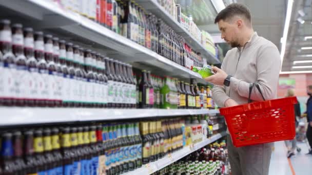 Hombre cliente compra cerveza embotellada en el supermercado — Vídeos de Stock