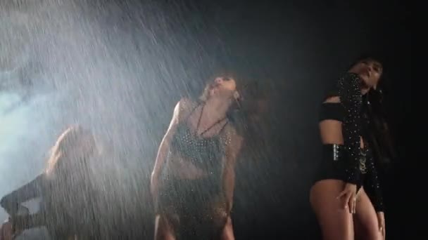 Sexuality and seduction of three young ladies dancing in darkness — Stock Video