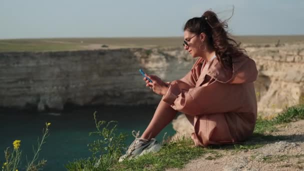 Женщина проводит время со смартфоном на природе — стоковое видео