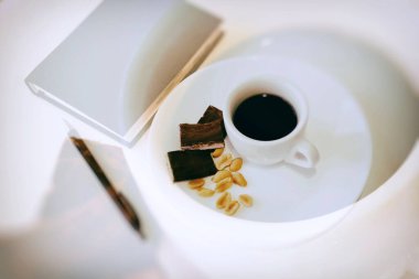 Fındıklı kahve ve beyaz masada çikolata.