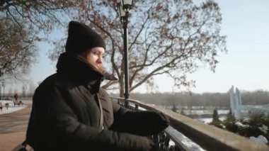 Açık havada bir kış parkında yürüyen güzel bir genç kadın. Soğuk, soğuk bir günde doğa parkında bir yürüyüş..