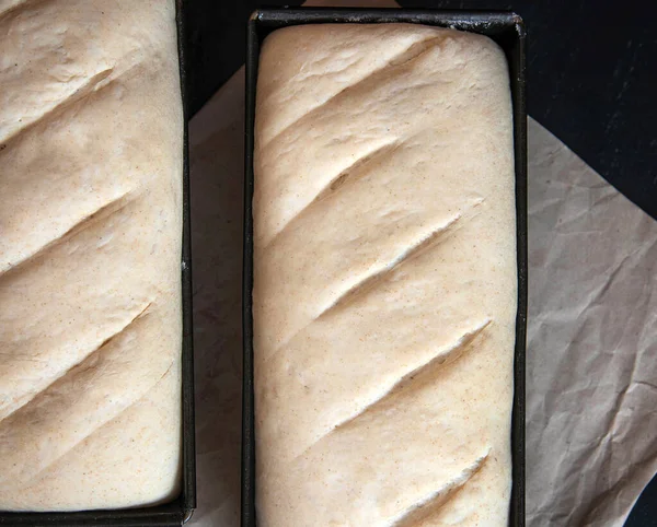 Bread dough before baking in a baking pan.