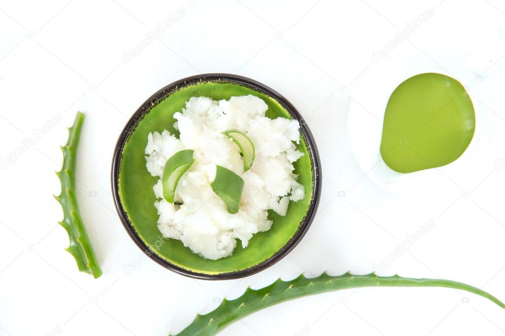 Coconut oil, aloe leaves and aloe gel on a white background.