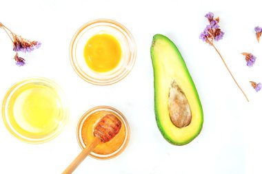 Doğal cilt bakım ürünleri, Avokado, yumurta, bal ve beyaz arka plan..