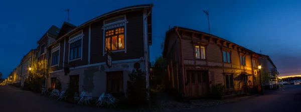 Wooden houses in a small street at dusk — Stock Photo, Image