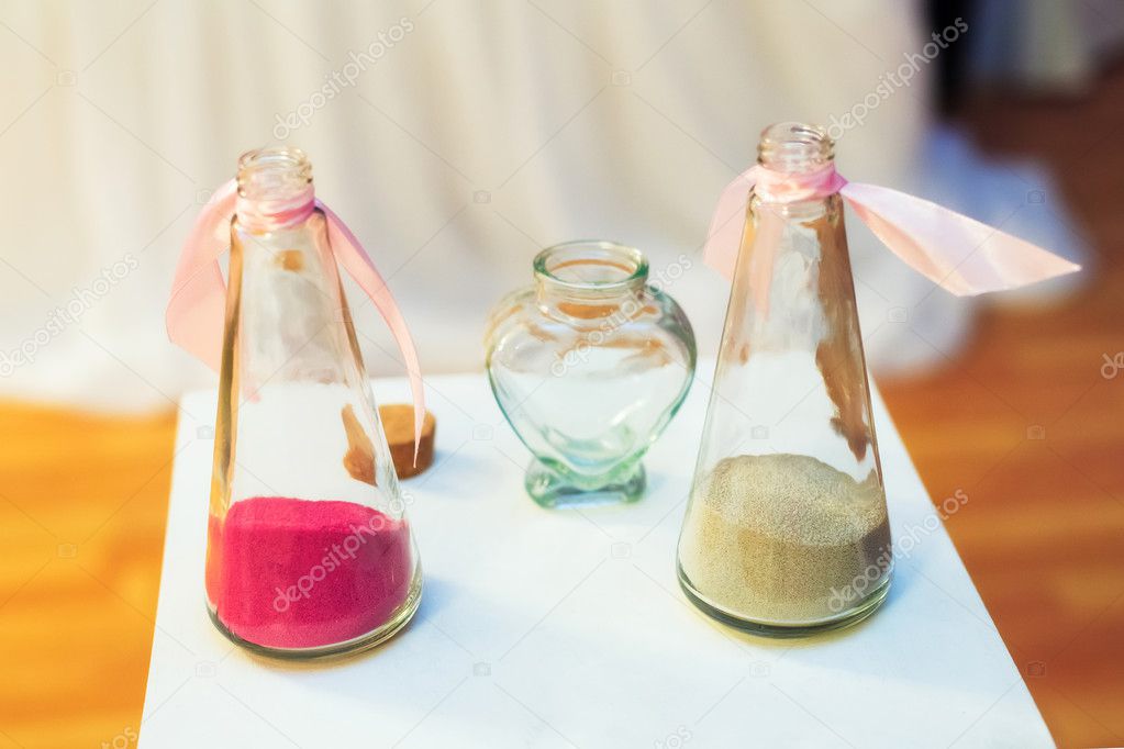 Sand ceremony on wedding, glass vases for bride and groom