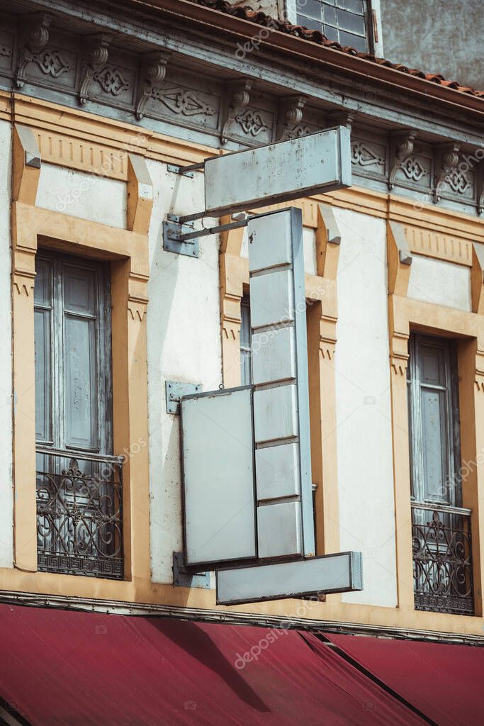 Large multi-zone shop sign mock-up on vintage European building facade with six vertical panels, two sideboards, and logo area, ideal for branding, lettering or advertising design presentation