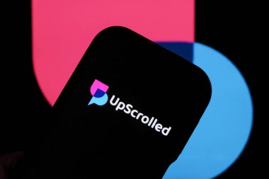 Bandung, Endonezya - 3 Şubat 2026: Bu fotoğraf ilüstrasyonlarında, UpScrolled uygulamasının logosu arka planda TikTok 'un görünür olduğu bir cep telefonunda sergilenmektedir.