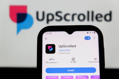 Bandung, Endonezya - 3 Şubat 2026: Bu fotoğraf ilüstrasyonlarında, UpScrolled uygulamasının logosu arka planda TikTok 'un görünür olduğu bir cep telefonunda sergilenmektedir.