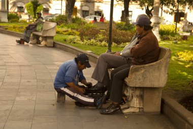 Riobamba, Ekvador, 27 Haziran 2019. Riobamba, Ekvador 'da bir sokakta ayakkabı boyacısı çalışıyor..