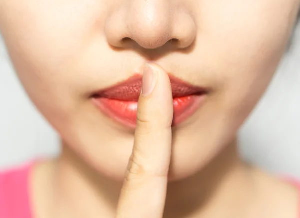 stock image closeup picture of woman making a hush gesture