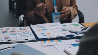 Finans belgesi ve mali muhasebe kavramının rakamlarını hesaplamak için hesap makinesi kullanan bir iş kadını