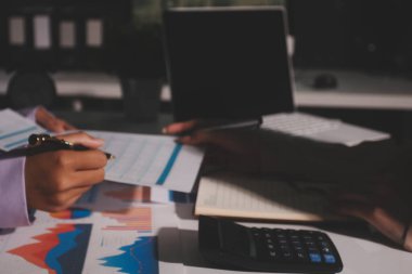 Above table with finance papers, graphs and big data during teamwork meeting with accounting or marketing team discussing budget, strategy or growth development. Closeup of SEO team doing research