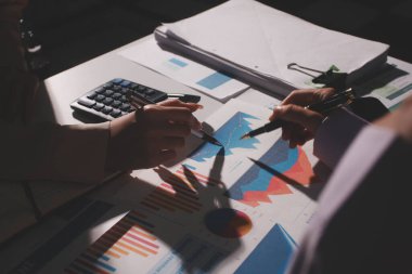 Above table with finance papers, graphs and big data during teamwork meeting with accounting or marketing team discussing budget, strategy or growth development. Closeup of SEO team doing research