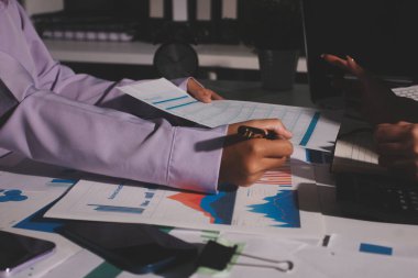 Above table with finance papers, graphs and big data during teamwork meeting with accounting or marketing team discussing budget, strategy or growth development. Closeup of SEO team doing research