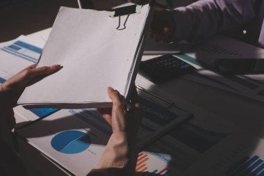 Above table with finance papers, graphs and big data during teamwork meeting with accounting or marketing team discussing budget, strategy or growth development. Closeup of SEO team doing research