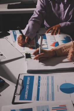Above table with finance papers, graphs and big data during teamwork meeting with accounting or marketing team discussing budget, strategy or growth development. Closeup of SEO team doing research