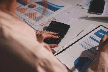 Above table with finance papers, graphs and big data during teamwork meeting with accounting or marketing team discussing budget, strategy or growth development. Closeup of SEO team doing research