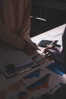 Above table with finance papers, graphs and big data during teamwork meeting with accounting or marketing team discussing budget, strategy or growth development. Closeup of SEO team doing research