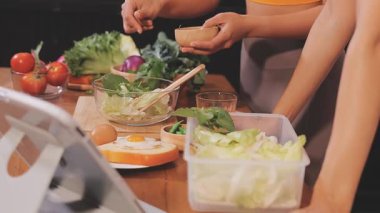 Kadın, sağlıklı yemek hazırlamak için mutfak tezgahında sebze kesiyor.