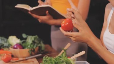 Kadın, sağlıklı yemek hazırlamak için mutfak tezgahında sebze kesiyor.