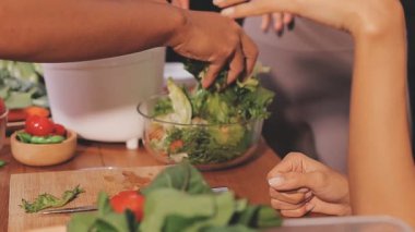 Kadın, sağlıklı yemek hazırlamak için mutfak tezgahında sebze kesiyor.