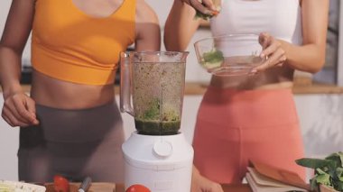 Kadın, sağlıklı yemek hazırlamak için mutfak tezgahında sebze kesiyor.