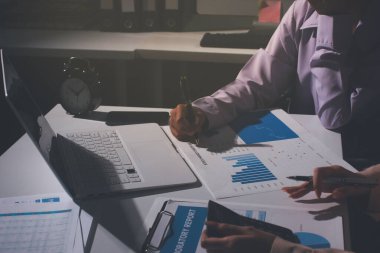 Above table with finance papers, graphs and big data during teamwork meeting with accounting or marketing team discussing budget, strategy or growth development. Closeup of SEO team doing research