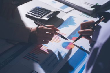 Above table with finance papers, graphs and big data during teamwork meeting with accounting or marketing team discussing budget, strategy or growth development. Closeup of SEO team doing research