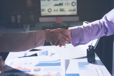 Above table with finance papers, graphs and big data during teamwork meeting with accounting or marketing team discussing budget, strategy or growth development. Closeup of SEO team doing research